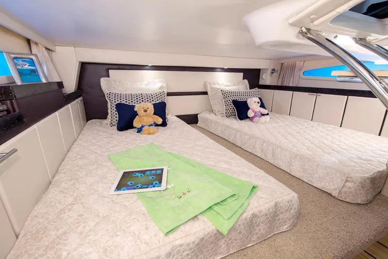 Slide: The Image of 2015 Regal 32 Express boat interior with beige seating and cup holders. - 6