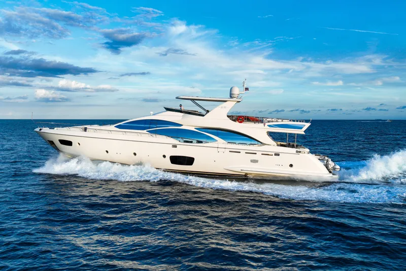 The Image of Luxurious 2010 Azimut 95 yacht cruising on open sea under clear blue sky. - 0