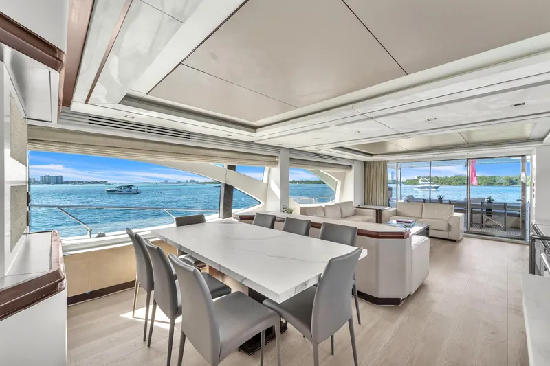 Slide: The Image of Luxurious interior of 2010 Azimut 95 yacht with elegant dining area and scenic ocean views. - 12