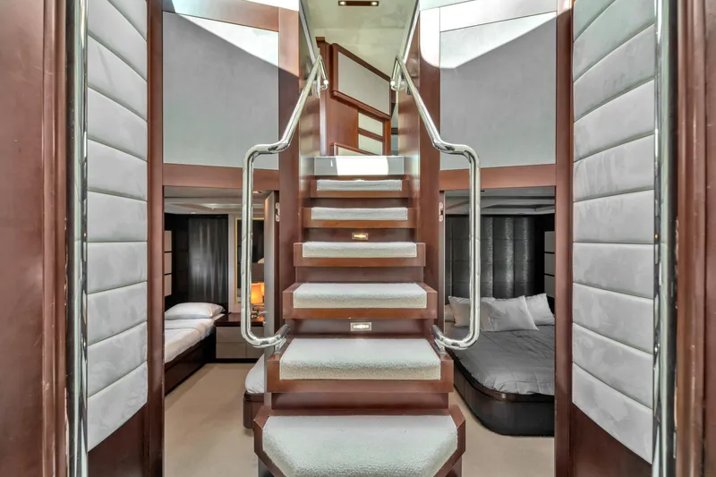 Slide: The Image of Luxurious interior of 2010 Azimut 95 yacht featuring elegant staircase and modern bedrooms. - 16