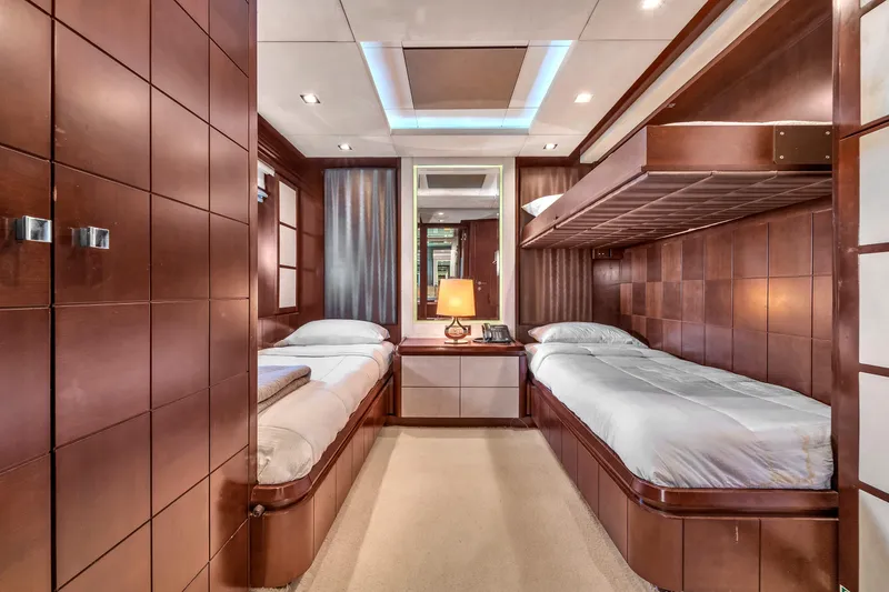 Slide: The Image of Luxurious cabin interior of 2010 Azimut 95 yacht with twin beds and elegant wood paneling. - 17