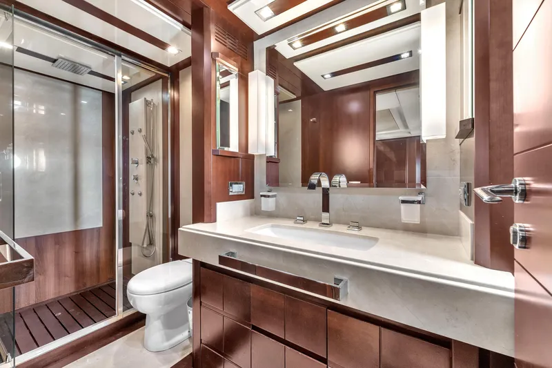 Slide: The Image of Luxurious bathroom interior on 2010 Azimut 95 yacht, featuring modern fixtures and elegant wood finishes. - 22