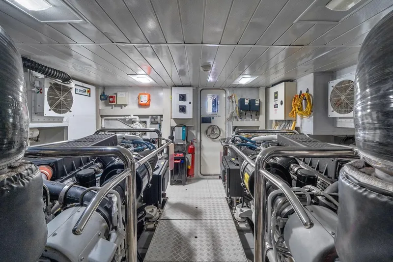 Slide: The Image of Engine room of a 2010 Azimut 95 yacht, featuring dual engines and control systems. - 25
