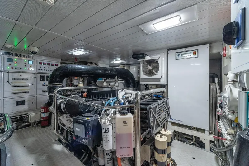 Slide: The Image of Engine room of a 2010 Azimut 95 yacht, featuring advanced machinery and control panels. - 26