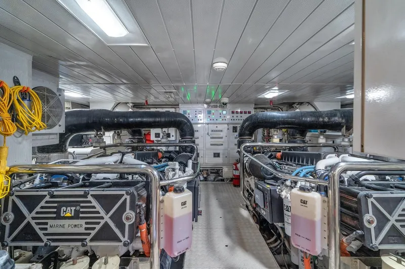 Slide: The Image of Engine room of a 2010 Azimut 95 yacht, featuring CAT marine power engines. - 27