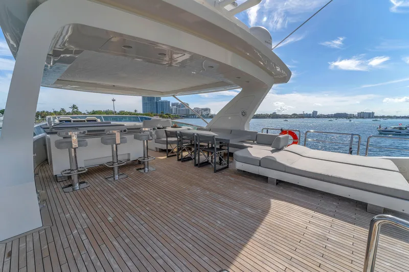 Slide: The Image of Luxurious 2010 Azimut 95 yacht deck with seating, bar stools, and ocean view. - 3