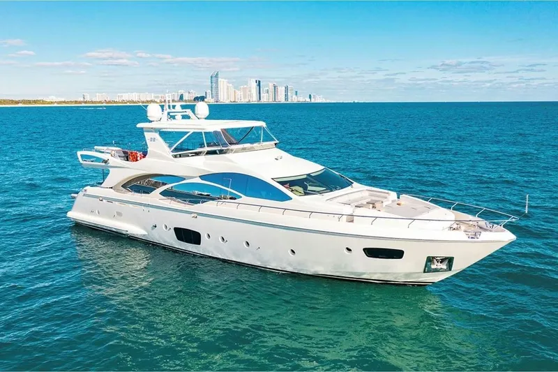 Slide: The Image of Luxurious 2010 Azimut 95 yacht cruising on blue ocean with city skyline backdrop. - 32