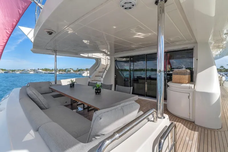Slide: The Image of Luxurious 2010 Azimut 95 yacht deck with seating, table, and ocean view. - 8