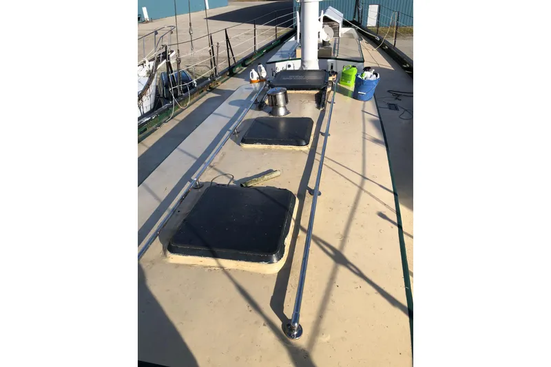 Slide: The Image of Deck of 1992 Treworgy 65 Schooner with hatches and cleaning supplies. - 10