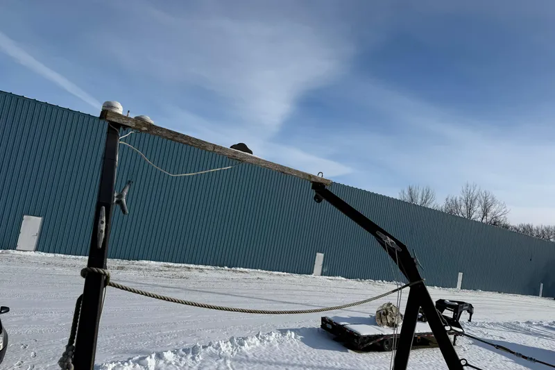 Slide: The Image of Outdoor scene with Treworgy 65 Schooner parts, snowy ground, and blue metal building. - 11