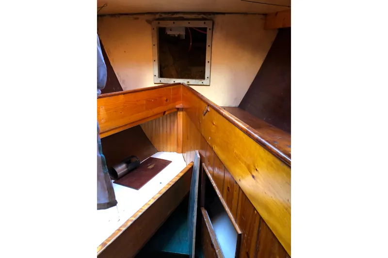Slide: The Image of Interior of 1992 Treworgy 65 Schooner with wooden paneling and storage compartments. - 27