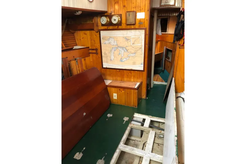 Slide: The Image of Interior of 1992 Treworgy 65 Schooner with nautical map and wooden paneling. - 28