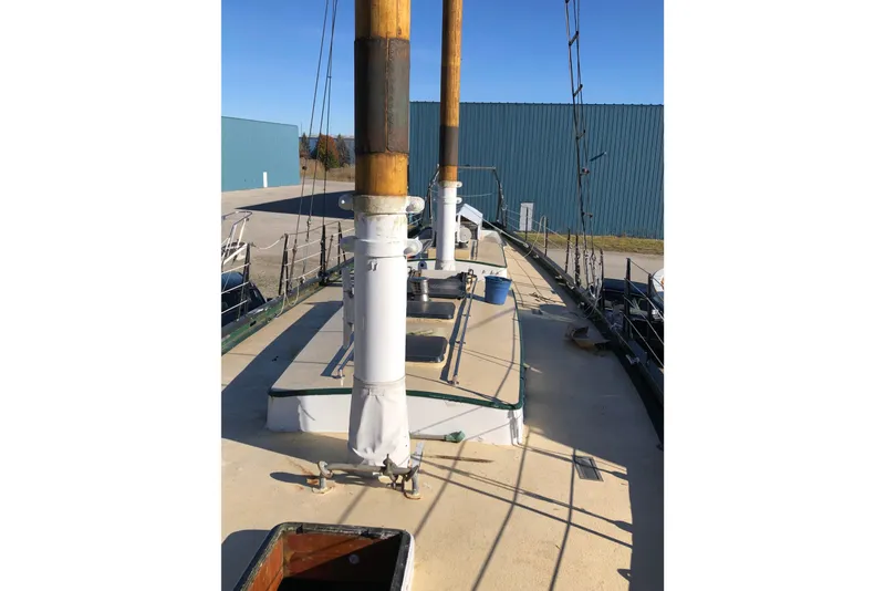 Slide: The Image of 1992 Treworgy 65 Schooner deck with masts and rigging in a marina setting. - 3