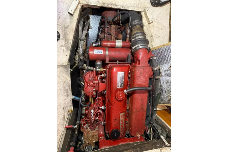 Slide: The Image of Red engine of a 1992 Treworgy 65 Schooner, showcasing intricate mechanical components. - 30