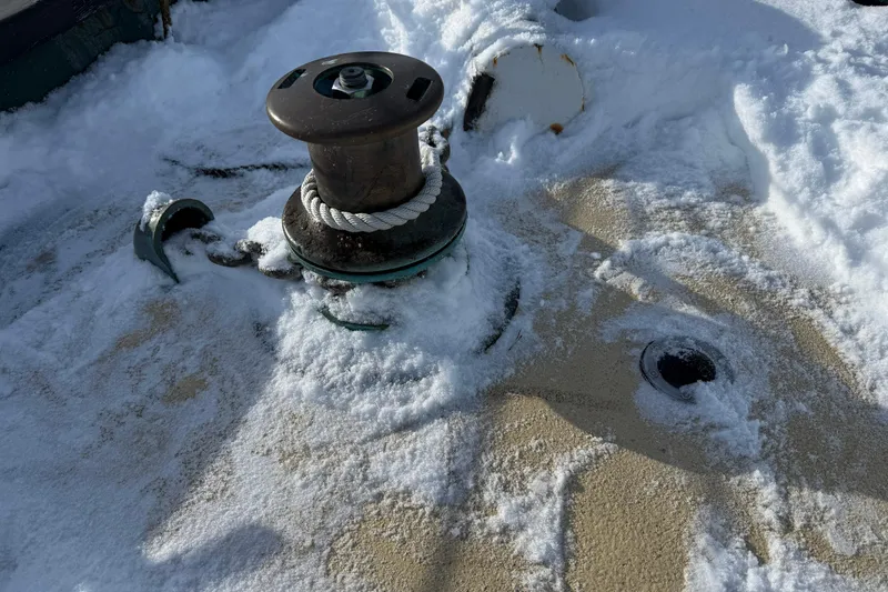 Slide: The Image of Snow-covered deck of 1992 Treworgy 65 Schooner with winch and rope. - 9