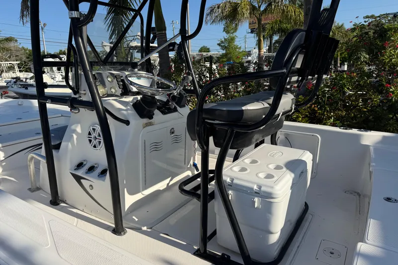 Slide: The Image of 2016 Blue Wave 2200 boat interior with steering console and seating. - 23