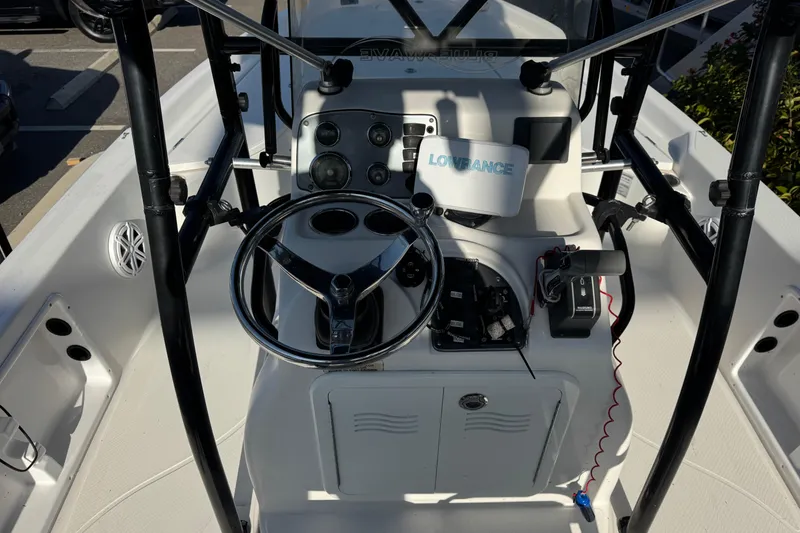 Slide: The Image of 2016 Blue Wave 2200 boat console with steering wheel and navigation equipment. - 29