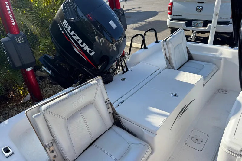 Slide: The Image of 2016 Blue Wave 2200 boat interior with Suzuki engine and white seating. - 31