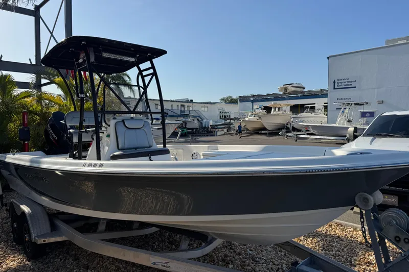 Slide: The Image of 2016 Blue Wave 2200 boat on trailer at marina, side view. - 7