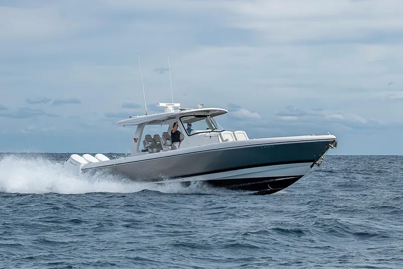 Slide: The Image of 2023 Intrepid 427 Nomad SE cruising on open water under a cloudy sky. - 100