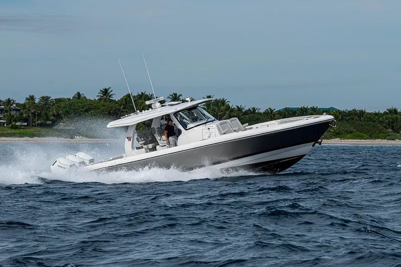 Slide: The Image of 2023 Intrepid 427 Nomad SE cruising on ocean near lush coastline. - 104