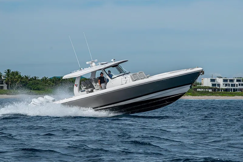 Slide: The Image of 2023 Intrepid 427 Nomad SE cruising on open water near coastline. - 105