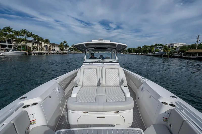 Slide: The Image of 2023 Intrepid 427 Nomad SE boat cruising on a scenic waterway. - 11