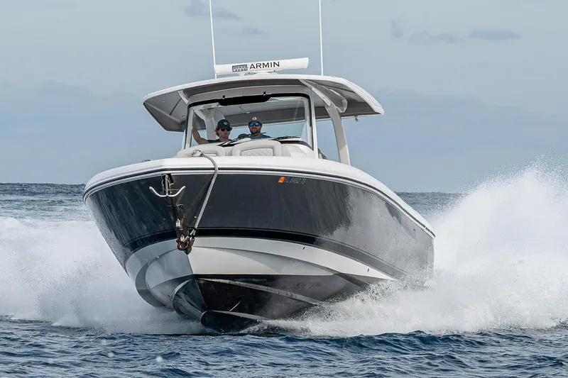 Slide: The Image of 2023 Intrepid 427 Nomad SE boat cruising on ocean waves. - 111