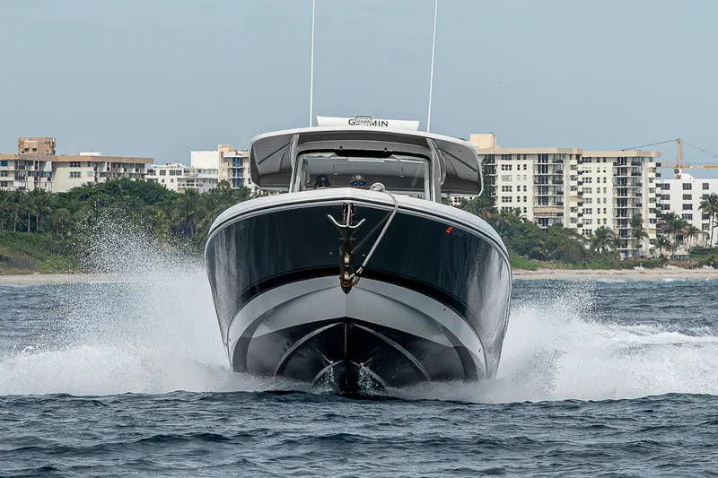 Slide: The Image of 2023 Intrepid 427 Nomad SE cruising on water near coastal buildings. - 117