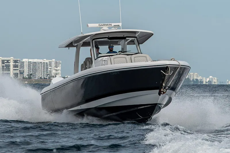 Slide: The Image of 2023 Intrepid 427 Nomad SE cruising on ocean near city skyline. - 118