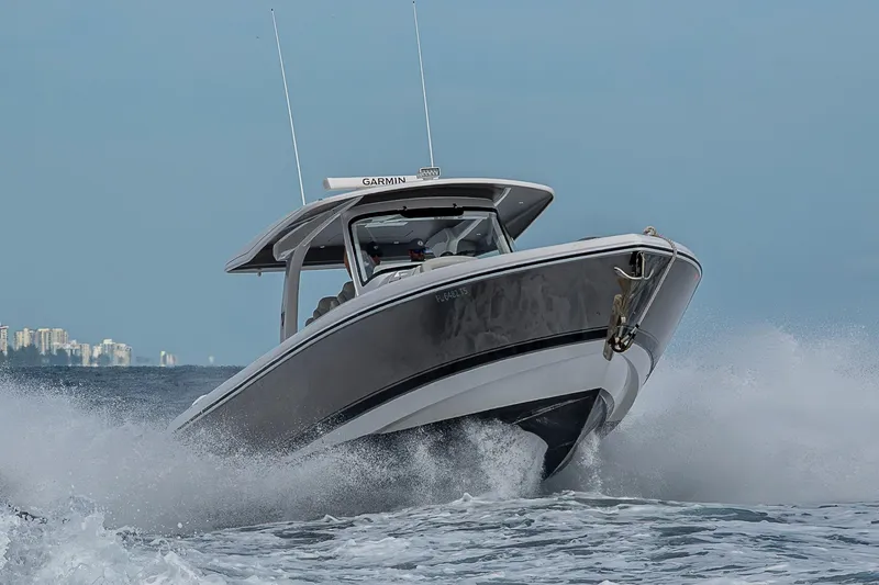 Slide: The Image of 2023 Intrepid 427 Nomad SE cruising on ocean waves, showcasing sleek design and performance. - 119