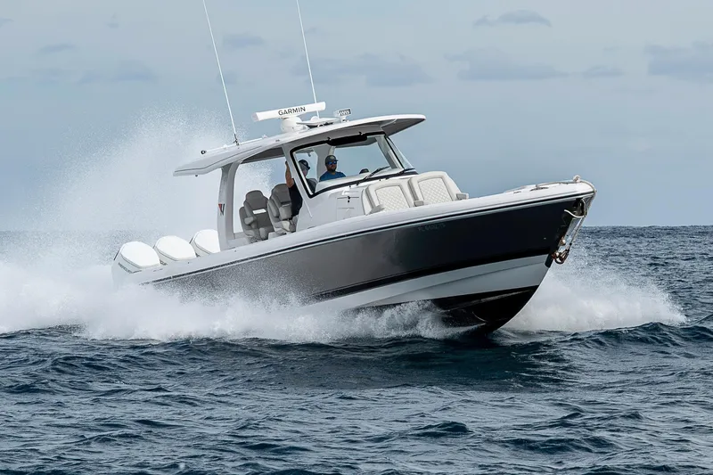 Slide: The Image of 2023 Intrepid 427 Nomad SE boat cruising on open water, showcasing sleek design and performance. - 122