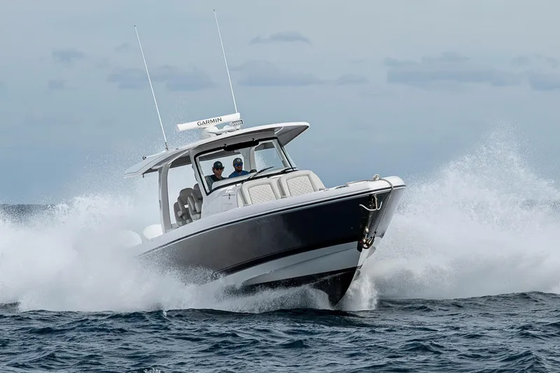 Slide: The Image of 2023 Intrepid 427 Nomad SE boat navigating through ocean waves. - 124