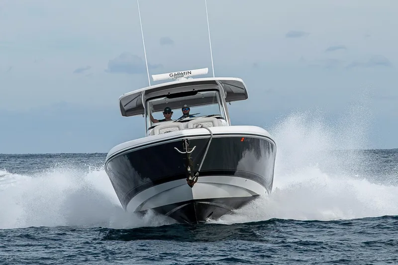 Slide: The Image of 2023 Intrepid 427 Nomad SE boat cruising on open water, creating splashes. - 126