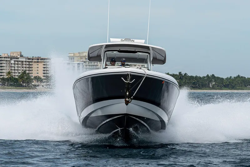 Slide: The Image of 2023 Intrepid 427 Nomad SE cruising on water with cityscape background. - 129