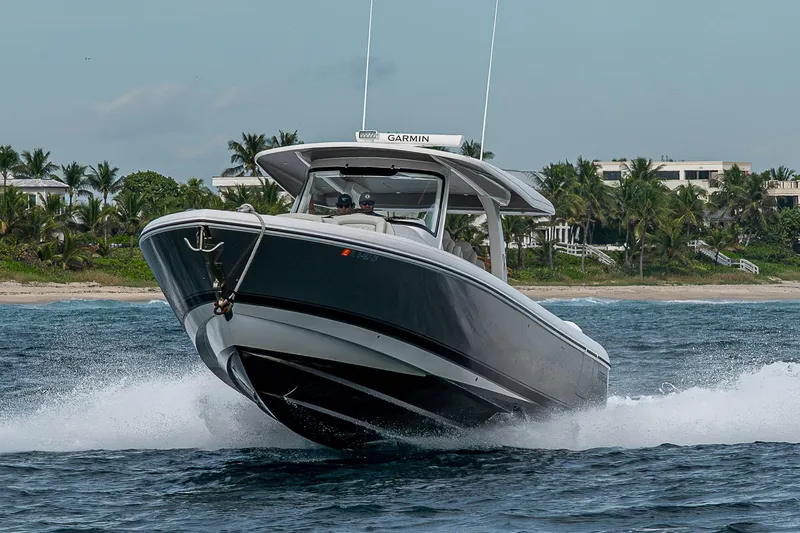 Slide: The Image of 2023 Intrepid 427 Nomad SE cruising on ocean near tropical shoreline. - 136