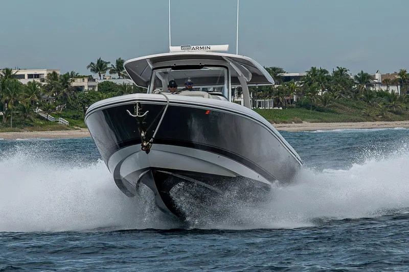 Slide: The Image of 2023 Intrepid 427 Nomad SE cruising on water near tropical shoreline. - 137