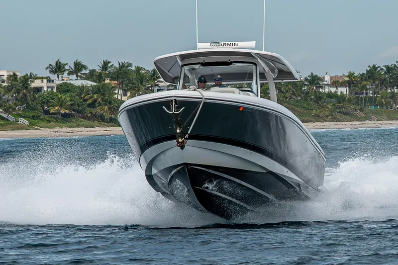 Slide: The Image of 2023 Intrepid 427 Nomad SE cruising on ocean near tropical coastline. - 138