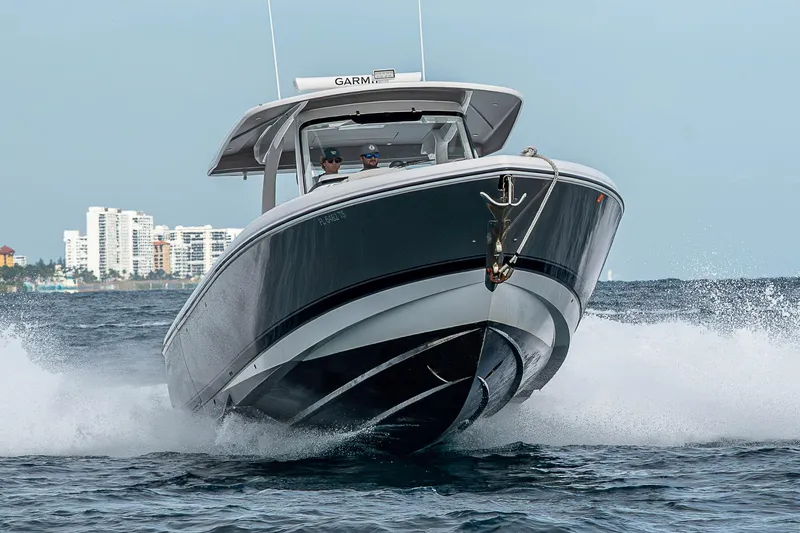 Slide: The Image of 2023 Intrepid 427 Nomad SE cruising on ocean near city skyline. - 139