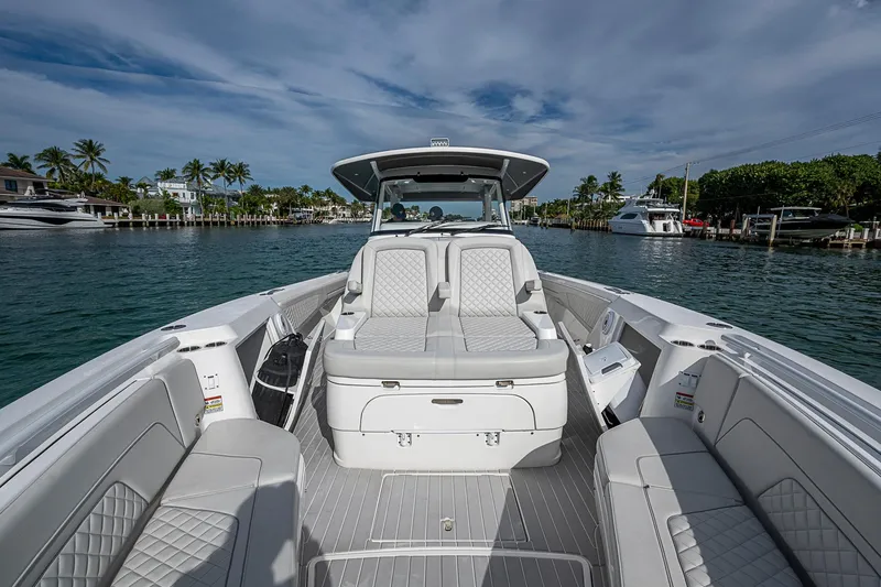 Slide: The Image of 2023 Intrepid 427 Nomad SE boat interior with luxurious seating on a sunny day. - 14