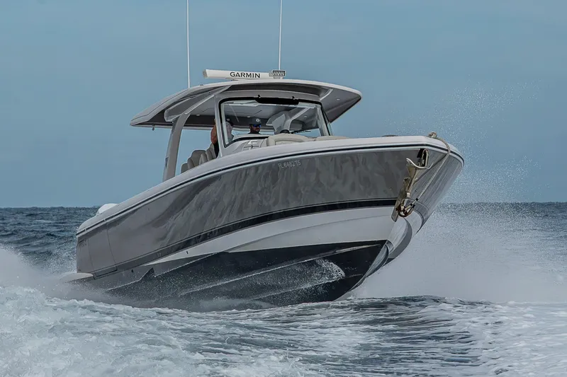 Slide: The Image of 2023 Intrepid 427 Nomad SE boat cruising on open water, showcasing sleek design and performance. - 140
