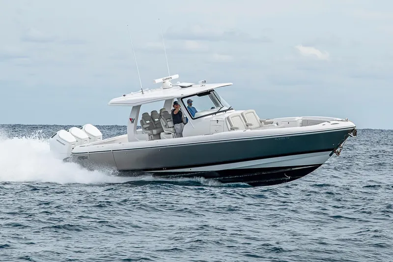 Slide: The Image of 2023 Intrepid 427 Nomad SE cruising on open water, showcasing sleek design and powerful engines. - 143