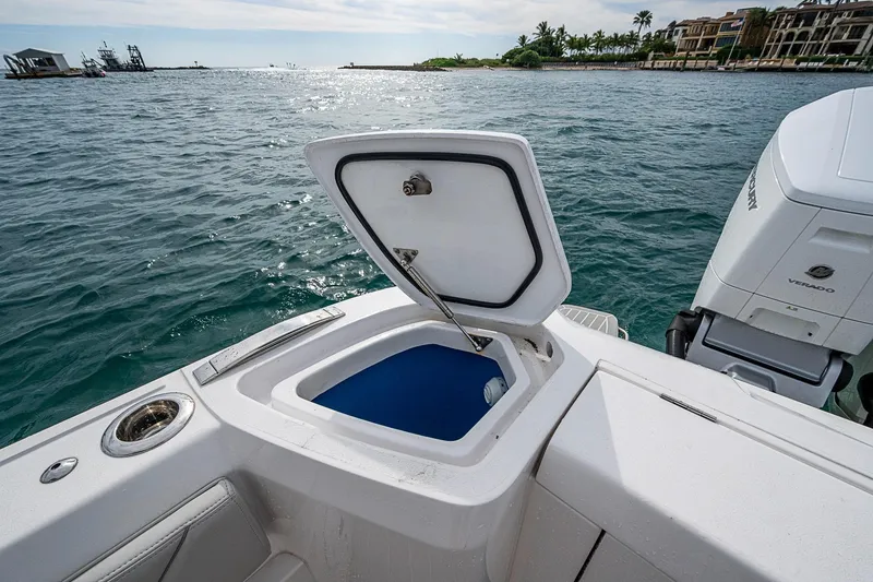Slide: The Image of 2023 Intrepid 427 Nomad SE boat with open storage compartment, ocean view. - 23