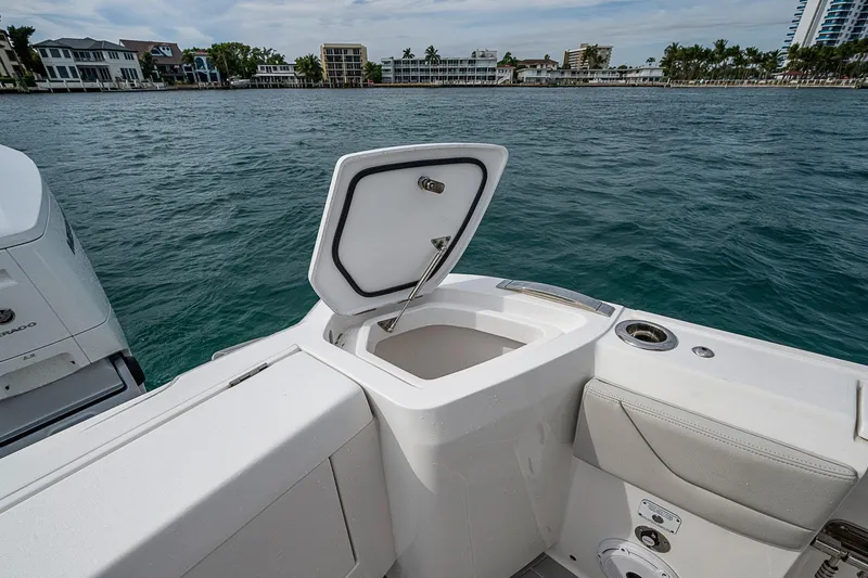 Slide: The Image of 2023 Intrepid 427 Nomad SE boat with open storage compartment, dockside view. - 24