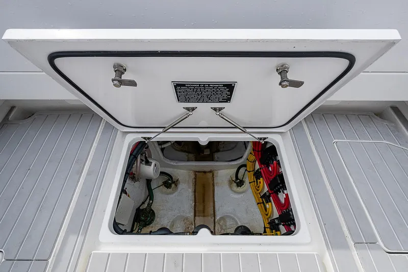 Slide: The Image of Open hatch of 2023 Intrepid 427 Nomad SE boat, revealing internal components and wiring. - 26