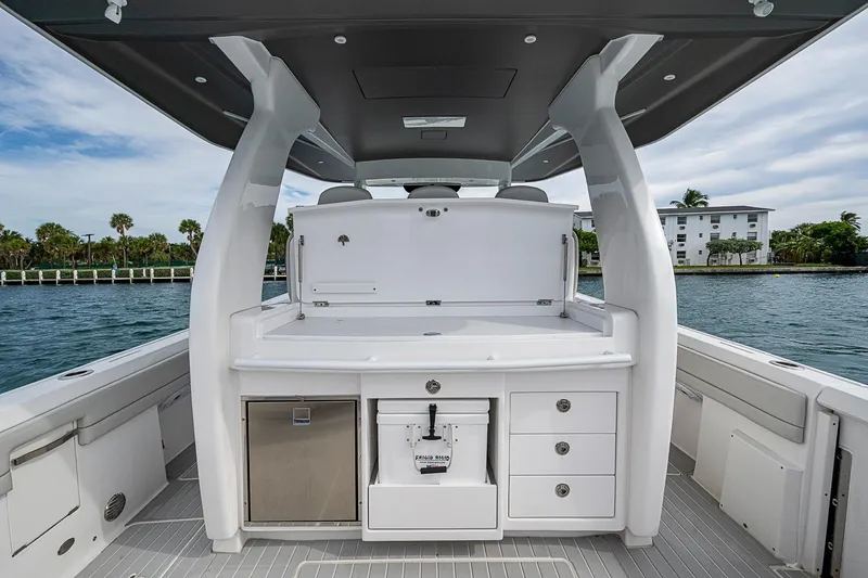 Slide: The Image of 2023 Intrepid 427 Nomad SE boat interior with sleek design and storage compartments. - 29