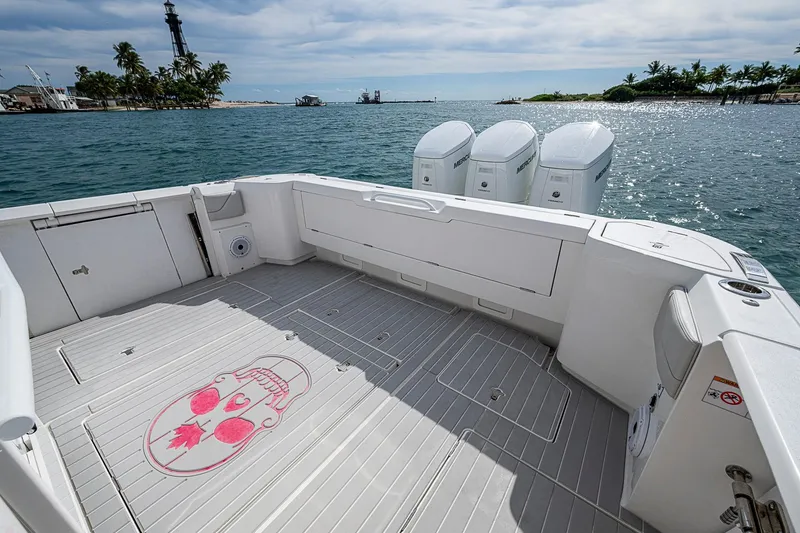 Slide: The Image of 2023 Intrepid 427 Nomad SE boat deck with skull design, ocean view, and palm trees. - 34