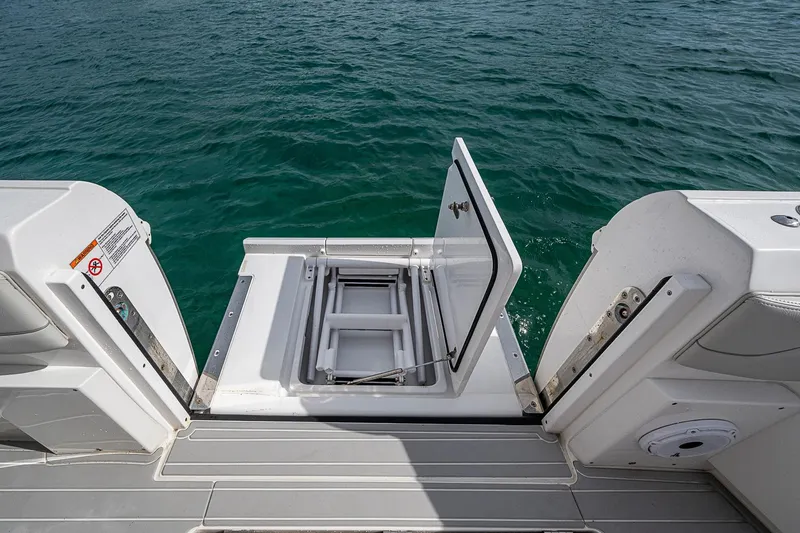 Slide: The Image of 2023 Intrepid 427 Nomad SE boat with open hatch, revealing storage compartment. - 36