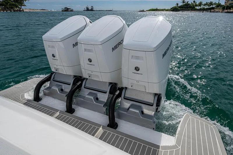 Slide: The Image of Triple Mercury Verado engines on 2023 Intrepid 427 Nomad SE, cruising in clear waters. - 37