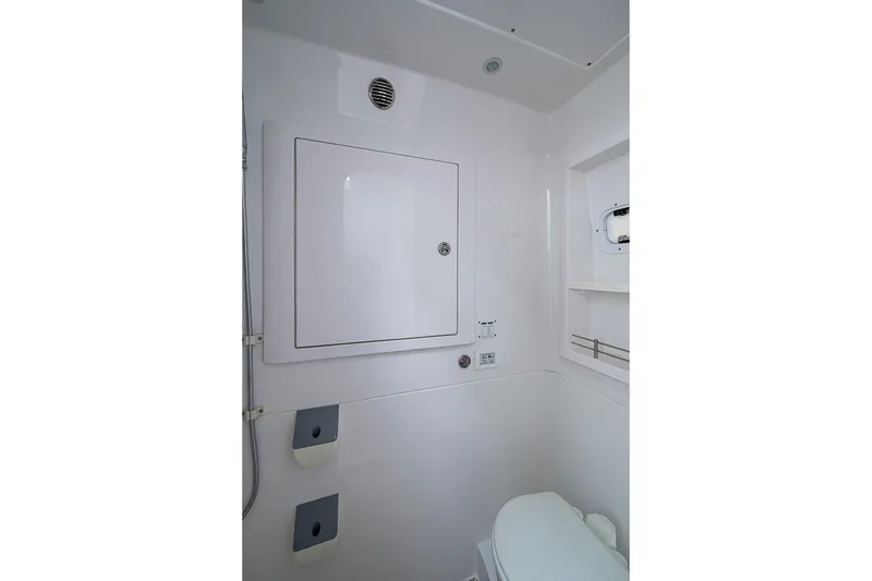 Slide: The Image of 2023 Intrepid 427 Nomad SE boat bathroom with white interior and compact design. - 41